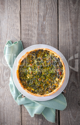 Fresh Spinache quiche on a wooden surface