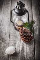 Christmas ornaments and old lamp on rustic wood