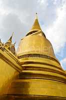 Golden pagoda inside emerald temple, thailand.