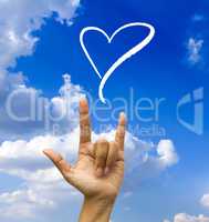 Gesturing hand on blue sky.