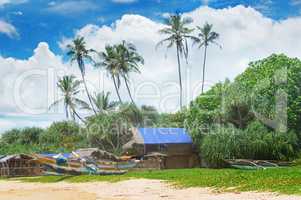 old fishing boats and huts on sandy beach