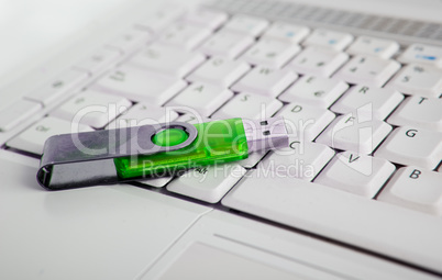 Laptop and green usb memory stick