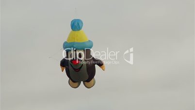 Figurative mole kite flying in front of cloudy sky