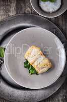 Fried cod fillets and spinach