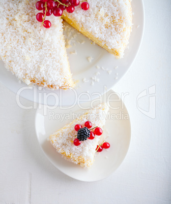 A piece of Homemade coconut cake on a white plate