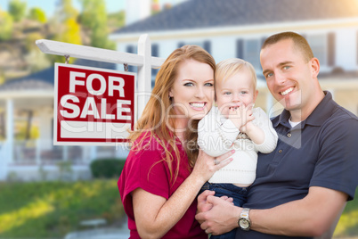 Young Military Family in Front of For Sale Sign and House
