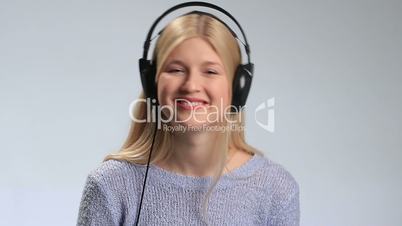 Young happy woman enjoying music with headphones.