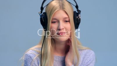 Cute teenage girl in headphones listening to music