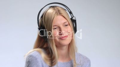 Beautiful woman listening to music in headphones