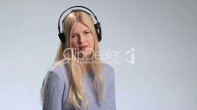 Expressive girl in headphones listening to music