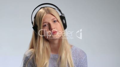 Sad girl with headphones listening to music
