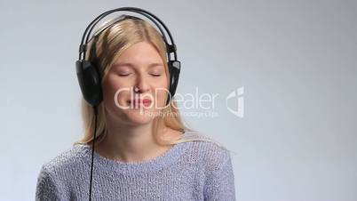 Happy teenage girl in headphones over white