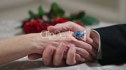 Senior male hand caressing elderly female hand
