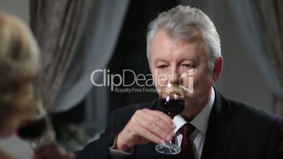 Mature man drinking glass of red wine