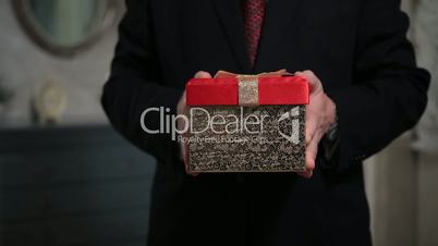 Senior person holding a gift pack