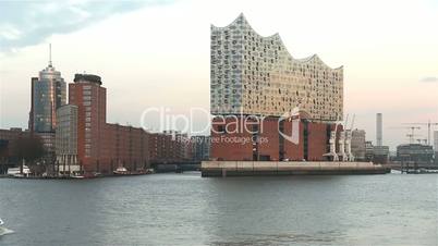 Elbphilharmonie in hamburg, germany in sunset with elbe river and tourist boat 2016