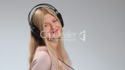 Emotional girl in headphones listening music