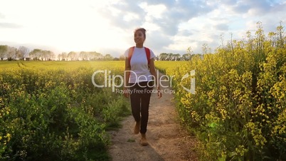 mixed race African American girl teenager female young woman hiking with red backpack