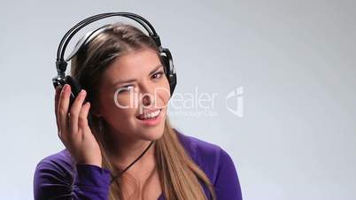 Cute smiling girl listening to music on headphones