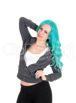 Woman standing with blue hair.