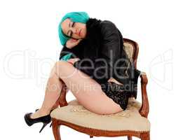 Woman sitting in armchair.