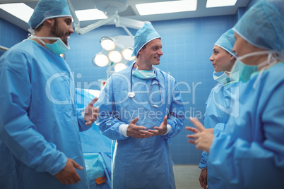 Team of surgeons having discussion in operation theater