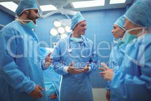 Team of surgeons having discussion in operation theater