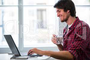 Graphic designer using laptop at his desk