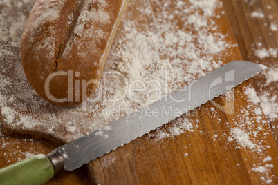 Sliced bread with knife on cutting board