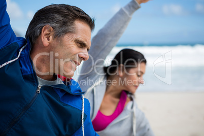 Couple performing stretching exercise