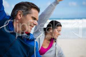 Couple performing stretching exercise