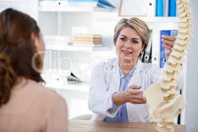 Doctor explaining anatomical spine to patient