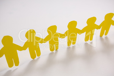 Row of yellow paper cut-out figures