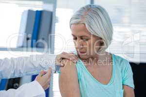 Doctor giving injection to patient