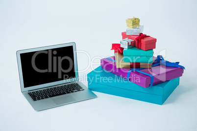 Stack of gift boxes with laptop