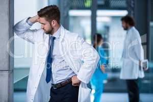 Stressed doctor standing in hospital