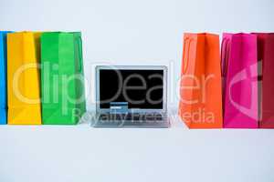 Colorful shopping bags and credit card with laptop