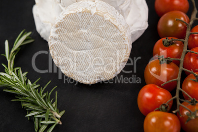 Cheese with cherry tomatoes and rosemary herb