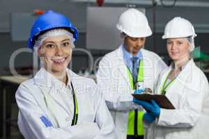 Technicians standing in meat factory
