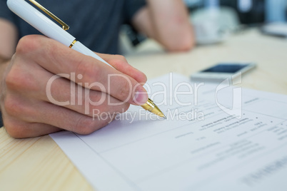 Business executive writing on a document