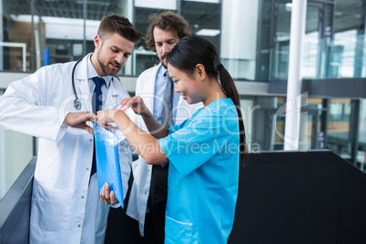 Doctor and nurse opening a file folder