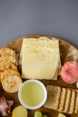 Variety of cheese with grapes, peach and crackers