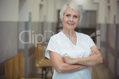 Portrait of female nurse standing in corridor