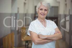 Portrait of female nurse standing in corridor