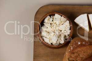 Cheese with bread on chopping board