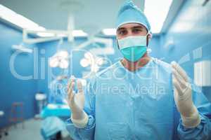 Portrait of male surgeon wearing surgical mask in operation theater