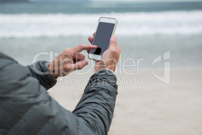 Man using mobile phone on beach