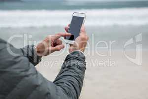 Man using mobile phone on beach