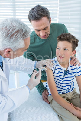 Doctor giving an injection to the patient