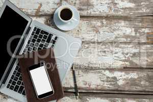 Laptop, smartphone and diary with coffee cup